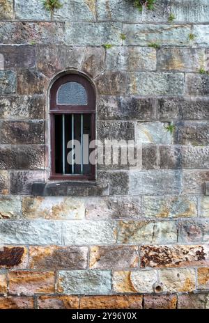 Vintage window set in a colourful sand stone wall, brickwall, abstract graphic design. Stock Photo