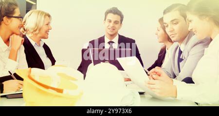 Students meeting with a teacher in a conference room Stock Photo