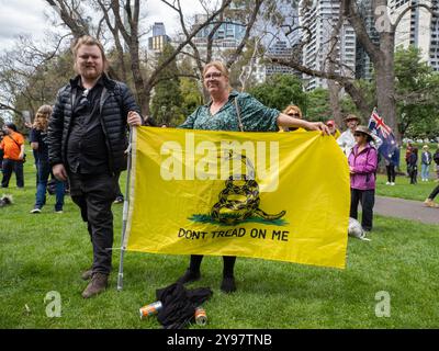 Melbourne, Australia. 05th Oct, 2024. A rally attendee proudly displays her Gadsden Flag during the rally. The Australian Libertarian Party held a public rally at Flagstaff Gardens espousing party policy; particularly opposition to the federal government's proposed Communications Legislation Amendment (Combatting Misinformation and Disinformation) Bill 2024, and the state of Victoria's proposed changes to anti-vilification laws. (Photo by Alex Zucco/SOPA Images/Sipa USA) Credit: Sipa USA/Alamy Live News Stock Photo