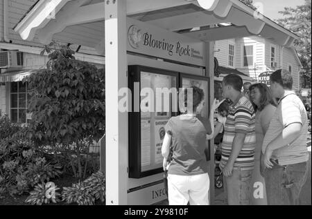 Tourists looking at a direction sign in the town of Blowing Rock, North Carolina, USA. Stock Photo