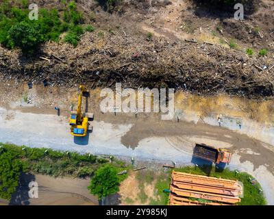 Landslides and natural disasters with excavators working on site. Natural disasters from flooding have damaged and cut off the road surface along the Stock Photo