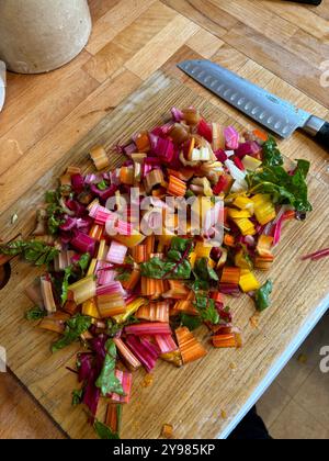 Chopped diced Swiss chard stalks on chopping board Stock Photo