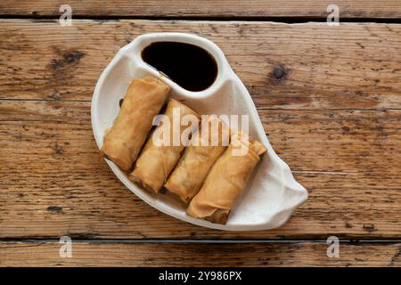 Duck spring rolls served with a soy sauce dip Stock Photo