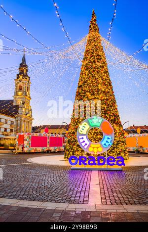 Oradea, Romania. Christmas Tree and winter fair, twinkling lights, holiday decorations, enjoying seasonal cozy atmosphere. Stock Photo