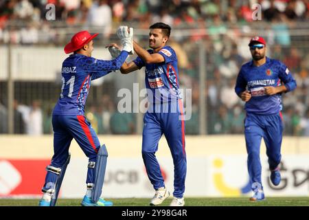 Fazalhaq Farooqi (M) celebrates one of his three wickets along teammates during Bangladesh and Afghanistan second T20 match of two match series at the Stock Photo