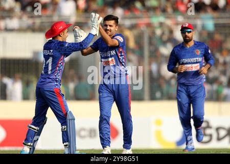 Fazalhaq Farooqi (M) celebrates one of his three wickets along teammates during Bangladesh and Afghanistan second T20 match of two match series at the Stock Photo