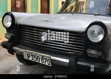 798 White and black European classic car -Peugeot 1960s to 70s- stationed on Callejon de Espada Alley, next to Calle Cuarteles Street. Havana-Cuba. Stock Photo