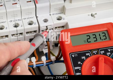 Measuring Voltage in Circuit Breaker with Multimeter Stock Photo