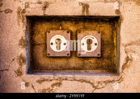 close up of a double lock set in the niche of a wall 2 locks Stock Photo