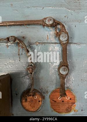 Remnants of electrical wiring in an abandoned rural house. Close-up. Stock Photo