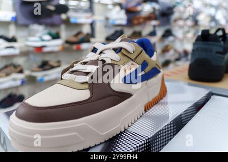 Tyumen, Russia-August 11, 2024: Close-up of a Fila sneaker showcasing the intricate lacing and design in a retail store Stock Photo