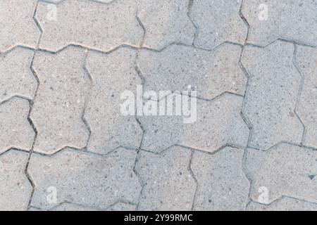 Mosaic Pattern of Interlocking Concrete Pavers in Soft Natural Light. Stock Photo