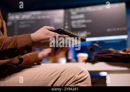 Focus on teleworking software developer working from home opening laptop to write programs in Java programming language on computer monitors in blurry background, close up shot Stock Photo