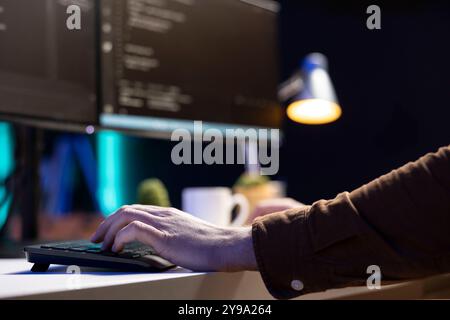 Freelancing computer technician futureproofing company network from downtimes and unexpected system failures. Tech support admin typing on keyboard, increasing data security, close up Stock Photo