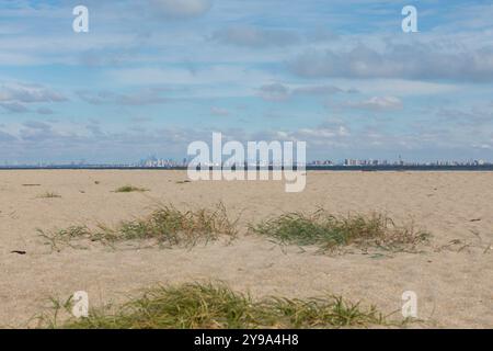 New York City is seen across the water from Sandy Hook, New Jersey. Brooklyn, including the famous Coney Island, can be seen in the front, with Manhat Stock Photo