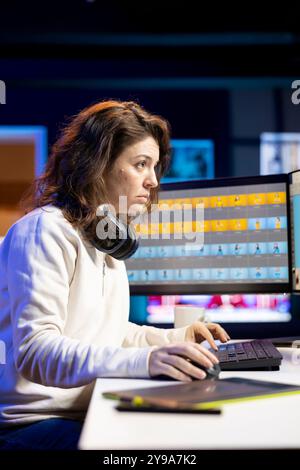 Freelancer in apartment studio working on digital portfolio showcasing photoshoot edited images. Photo editor selecting best photographs using retouching software interface Stock Photo