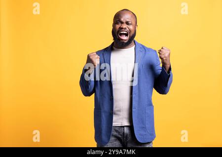 Heartbroken man screaming in pain, having mental breakdown, isolated over studio background. Desperate troubled person in distress, suffering tragedy, mourning and showing sorrow Stock Photo