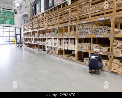 A shopper in the wood building materials section of a Menards home improvement store in Davison Michigan USA Stock Photo