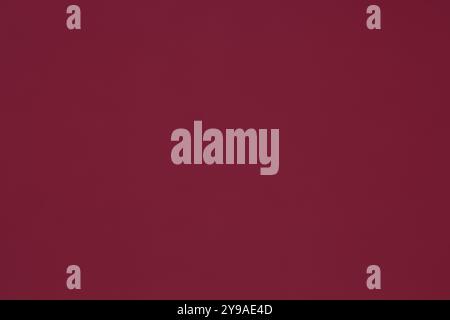 This paper background in a uniform dark red color, resembling maroon, is perfect for various uses. Stock Photo