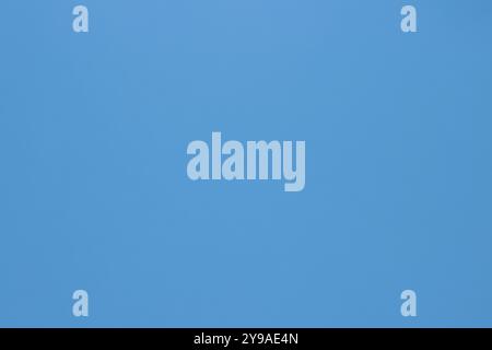 This paper background in a light blue color with a smooth texture is perfect for various uses. Stock Photo
