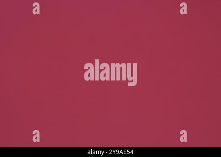 This paper background in a uniform magenta color is perfect for various uses. Stock Photo