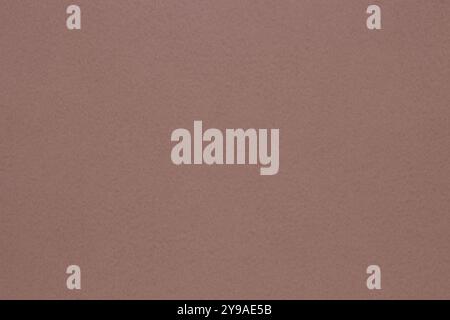 This paper background in a uniform pinkish-brown color with a fine grainy texture is perfect for various uses. Stock Photo