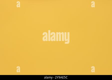 This paper background in a uniform yellow color is perfect for various uses. Its bright and vibrant color makes it an excellent choice Stock Photo