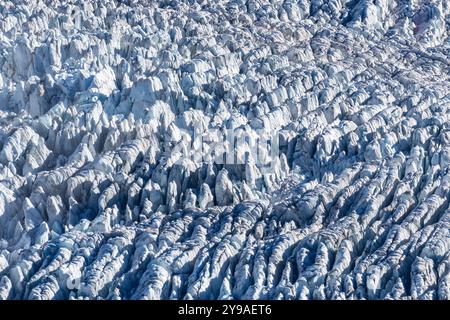 Highly textured glacial snow and ice with linear formations created by pressure and motion. Stock Photo