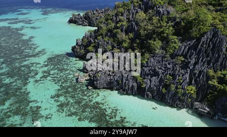 Aerial view of tropical Philippines island. White sand beach, rocks cliffs mountains with blue bay and beautiful coral reef Stock Photo