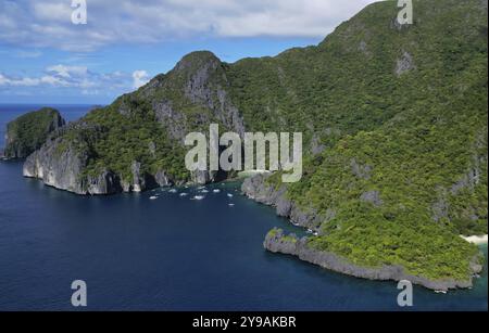 Aerial view of tropical Philippines island. White sand beach, rocks cliffs mountains with blue bay and coral reef Stock Photo