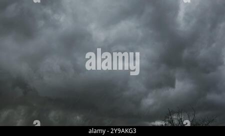 Dramatic dark storm clouds and heavy rainfall Stock Photo