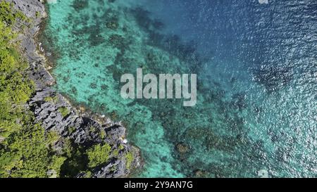 Aerial view of tropical island in Philippines. Blue lagoon, white sand beach, rocks cliffs mountains and coral reef Stock Photo