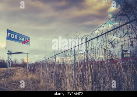 A For Sale Billboard Sign In An Urban Industrial Wasteland Or Vacant Lot Stock Photo