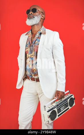 Mature, man and stereo in vintage fashion with confidence, sunglasses or trendy outfit in studio. Retro aesthetic, black person or hipster style on Stock Photo
