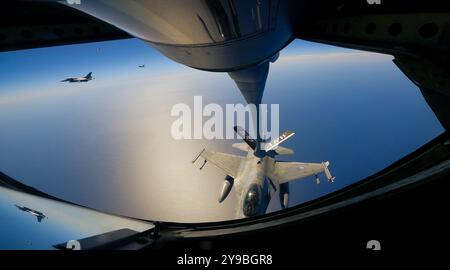 Three Greek F-16 Fighting Falcon aircraft practice air refueling with a U.S. Air Force KC-135 Stratotanker aircraft, assigned to the 100th Air Refueli Stock Photo