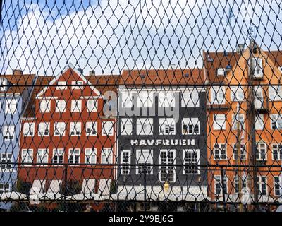 Copenhagen, Denmark - 9 October, 2022: A view through the chain-link fence towards the most touristy part of Copenhagen, with the old buildings along Stock Photo