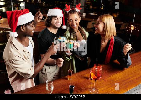 Young professionals gather, raising glasses in festive cheer during a corporate celebration. Stock Photo