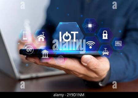 Smart business IOT, internet of things concept. Businessman use laptop with virtual IOT icon for connecting to internet to access AI artificial intell Stock Photo