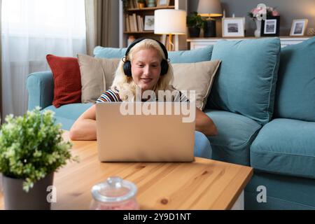Young introvert freelancer businesswoman with ADHD working remotely from home office on laptop computer. Business person avoiding crowded office and p Stock Photo