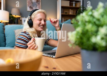 Young introvert freelancer businesswoman with ADHD working remotely from home office on laptop computer. Business person avoiding crowded office and p Stock Photo