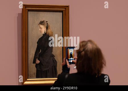 Amsterdam, Netherlands. 9th Oct, 2024. A woman takes photos of an exhibit during the exhibition 'Long Live Impressionism!' during the press preview at the Van Gogh Museum in Amsterdam, the Netherlands, Oct. 9, 2024. The exhibition is held to celebrate the 150th anniversary of Impressionism, featuring masterpieces by renowned Impressionists of the late 19th century. Credit: Sylvia Lederer/Xinhua/Alamy Live News Stock Photo