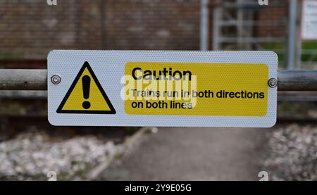 A warning sign at a footpath crossing at Kingswear on the Dartmouth Steam Railway, South Devon. Stock Photo