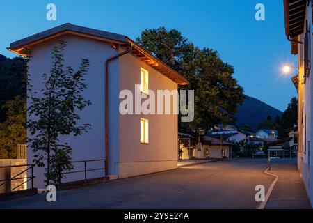 Newly renovated house, with modern finishes, night scene. Next to the house is the main road of the small village in Switzerland. Stock Photo