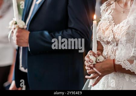 A Serene Moment of Unity Illuminated by Candlelight in a Wedding Ceremony. Stock Photo