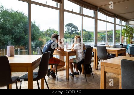 Two customers waiting to be served inside the Lakeside Restaurant cafe in Newquay in Cornwall in the UK. Stock Photo
