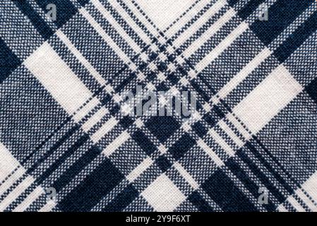 The texture of linen fabric in a large cage of blue  and white. Scottish tailoring material. Checkered fabric Stock Photo