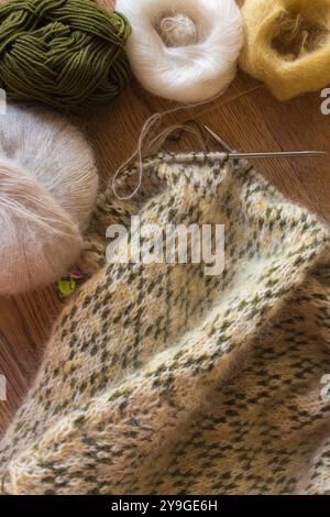 Norwegian knitted pattern with three balls of yarn and knitting needles. Spot sweater crochet. Knitting hobby. Knitwear concept. Needlework background Stock Photo
