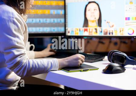 Freelancer in home studio working on digital portfolio showcasing photoshoot edited images, close up shot. Photo editor selecting best photographs using computer software in office Stock Photo