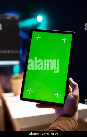 Programmer using isolated screen tablet to fix vulnerabilities in software, close up. Man taking care of security exposures in operating system, writing code on chroma key portable device Stock Photo