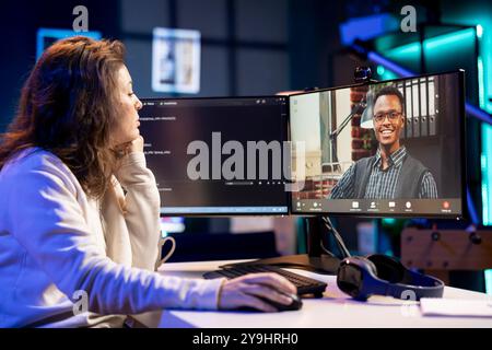 Admin doing company software debugging, talking with management in videocall about errors found in code. IT employee sharing coding mistakes found with board of directors in online teleconference Stock Photo